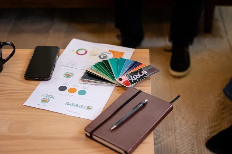 Brand colour palette, swatches and a notebook on a table