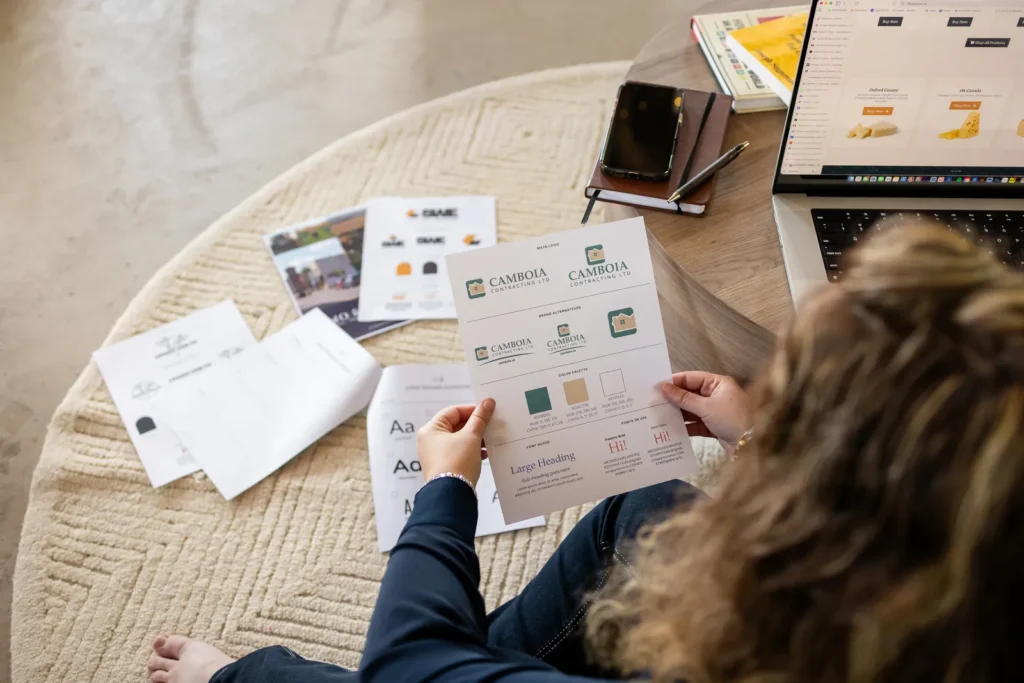 Reviewing printed brand sheets on the floor
