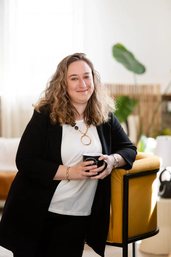 Kristen Jerry holding a coffee mug in her studio