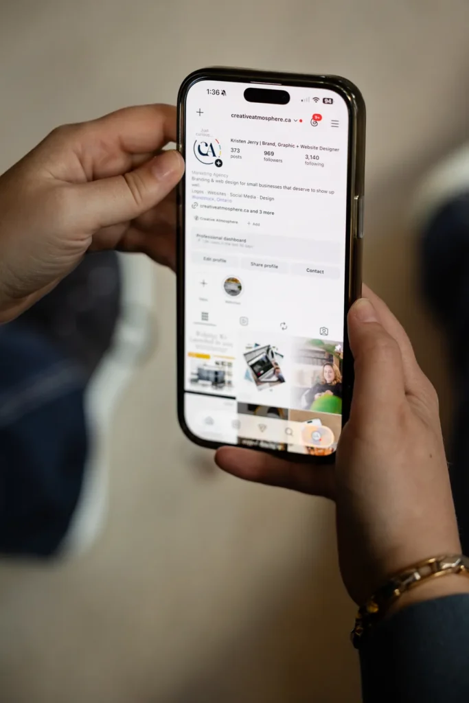 Phone showing the Creative Atmosphere Instagram profile