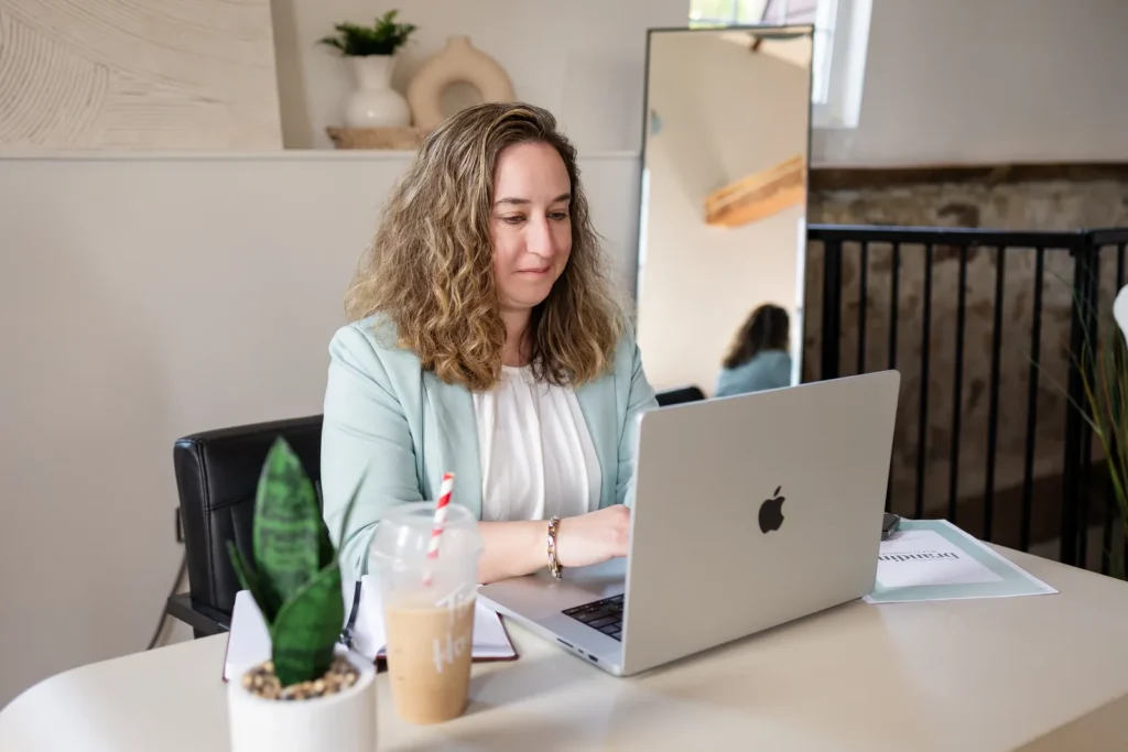 Kristen Jerry working on a laptop at her desk