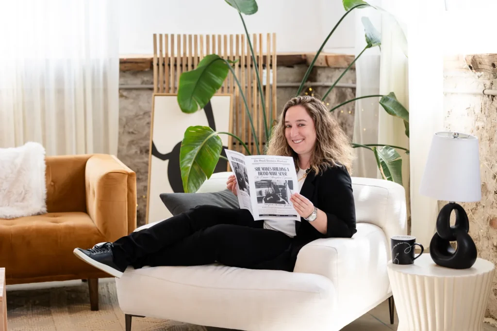 Kristen Jerry reading a magazine feature about Creative Atmosphere