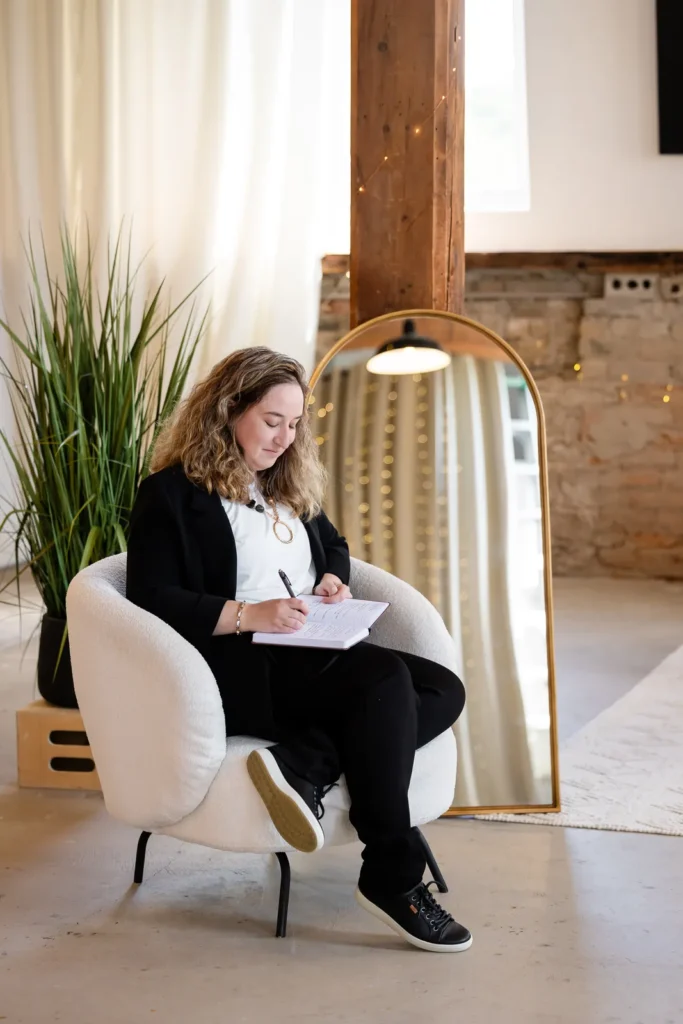 Kristen Jerry writing notes in an armchair