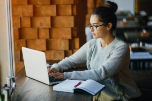 Girl working on a laptop at a restaurant